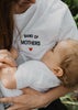 Our organic nursing top “Band of Mothers“ made of 100% premium organic cotton has lateral openings on both sides of the t-shirt closed by easy-to-open snap buttons. Our breastfeeding t-shirts are soft like a cocoon! The nursing top is white, has a loose fit and has a navy blue embroidery “Band of Mothers” with a red heart - on the left side - close to the heart.